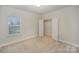 This bedroom is carpeted and features a closet, window, and neutral walls at 159 Rubys Way # 35, Oakboro, NC 28129