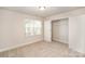 Bright bedroom features neutral walls, carpet, a closet with shelving, and a window overlooking the outdoors at 159 Rubys Way # 35, Oakboro, NC 28129