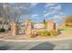 Entrance to the Ruby Ridge community with brick pillars, lush landscaping, and scenic street view at 159 Rubys Way # 35, Oakboro, NC 28129
