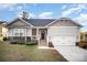 Charming single-Gathering home with gray siding, stone accents, and a welcoming front porch at 159 Rubys Way # 35, Oakboro, NC 28129