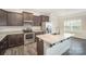 Stylish kitchen with granite countertops, stainless steel appliances, and a functional island at 159 Rubys Way # 35, Oakboro, NC 28129