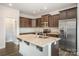 Well-appointed kitchen with stainless steel appliances, island with sink, and ample cabinet space at 159 Rubys Way # 35, Oakboro, NC 28129