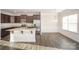 Well-lit kitchen with stainless steel appliances, granite counters, and dark wood cabinets at 159 Rubys Way # 35, Oakboro, NC 28129