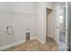 A neutral laundry room with a shelf, an open closet, and vinyl flooring at 159 Rubys Way # 35, Oakboro, NC 28129