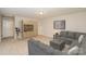This living room is carpeted and has neutral walls, recessed lighting, and a gray sofa at 159 Rubys Way # 35, Oakboro, NC 28129