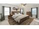Stylishly decorated main bedroom with a decorative rug, wooden furniture, and ample natural light at 159 Rubys Way # 35, Oakboro, NC 28129