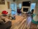 Spacious living room featuring hardwood floors, fireplace, and ample natural light at 1801 Brandywine Dr, Matthews, NC 28105