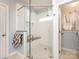 Large walk-in shower with a built-in seat and pebble flooring at 1801 Brandywine Dr, Matthews, NC 28105