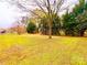 Large backyard features mature trees and a well-maintained lawn, perfect for outdoor enjoyment at 1905 26Th Ne St, Hickory, NC 28681