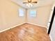 Bedroom with hardwood floors, ceiling fan, and two windows providing natural light at 1905 26Th Ne St, Hickory, NC 28681