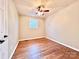 Bright bedroom features hardwood floors, ceiling fan, and a window providing natural light at 1905 26Th Ne St, Hickory, NC 28681