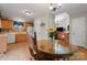 Bright dining area adjacent to kitchen, with a glass table, wood chairs, and views to the living room at 307 Tara Elizabeth Pl # 22, Kannapolis, NC 28083