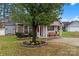 Curb appeal with stone details, front porch, and mature tree in the front yard at 307 Tara Elizabeth Pl # 22, Kannapolis, NC 28083