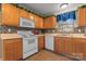 Well-lit kitchen featuring wooden cabinets, a tiled backsplash, and modern appliances at 307 Tara Elizabeth Pl # 22, Kannapolis, NC 28083