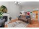 Spacious living room featuring a fireplace, chandelier, and wood flooring, creating an inviting atmosphere at 307 Tara Elizabeth Pl # 22, Kannapolis, NC 28083