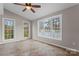 Bright room with tile flooring, neutral walls, a ceiling fan, and multiple windows with natural light at 307 Tara Elizabeth Pl # 22, Kannapolis, NC 28083