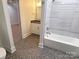 Bathroom with a vanity, tub, and hexagon tile floors at 405 19Th Avenue Nw Cir, Hickory, NC 28601