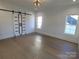 Bright bedroom with hardwood floors, barn door, and large windows at 405 19Th Avenue Nw Cir, Hickory, NC 28601