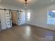 Main bedroom with hardwood floors, barn doors and multiple windows at 405 19Th Avenue Nw Cir, Hickory, NC 28601