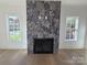 Modern herringbone-patterned tile fireplace at 405 19Th Avenue Nw Cir, Hickory, NC 28601