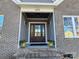 Dark stained front door entry with brick and board and batten exterior at 405 19Th Avenue Nw Cir, Hickory, NC 28601