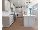 Modern kitchen with light gray cabinets, marble countertops, and island at 405 19Th Avenue Nw Cir, Hickory, NC 28601