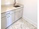 Laundry room with sink, cabinets, and quartz countertop at 405 19Th Avenue Nw Cir, Hickory, NC 28601