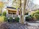 Cozy cottage with a tree-lined walkway and well-maintained landscaping at 716 Ellsworth Rd, Charlotte, NC 28211