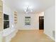 Open living room with built-in shelving and hardwood floors at 716 Ellsworth Rd, Charlotte, NC 28211