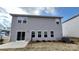 Backyard featuring a sliding door, a small concrete patio, gray siding, and minimal, newly planted landscaping at 111 Sentinel Ct, Mooresville, NC 28115