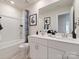 Bright bathroom featuring double sink vanity, framed mirror, and a tub with shower and stylish blue patterned shower curtain at 111 Sentinel Ct, Mooresville, NC 28115