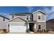 Charming two-story home featuring a stone accent, a two-car garage, and manicured landscaping at 111 Sentinel Ct, Mooresville, NC 28115