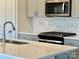 Close-up of a modern kitchen with stainless steel appliances and a white countertop at 111 Sentinel Ct, Mooresville, NC 28115