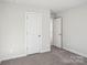 Bedroom with grey carpet and two doors at 1345 31St Ne St, Conover, NC 28613