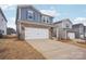 Two-story house with gray siding, brick accents, and a two-car garage at 1345 31St Ne St, Conover, NC 28613