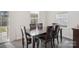 Dining area with dark wood table and six chairs at 1356 Augustus Beamon Dr, Indian Trail, NC 28079