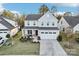 Two-story house with gray siding, red door, and a two-car garage at 1356 Augustus Beamon Dr, Indian Trail, NC 28079