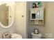 Small bathroom with white vanity, toilet, and medicine cabinet at 140 Rock Ridge Ln, Mount Holly, NC 28120