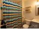 Neat bathroom with a colorful shower curtain and shelves at 140 Rock Ridge Ln, Mount Holly, NC 28120