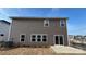 Exterior view of the back of the house with a modern patio and manicured lawn at 148 Shepherds Landing Dr, Mooresville, NC 28115