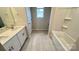 Bright bathroom featuring a single sink vanity and bathtub at 148 Shepherds Landing Dr, Mooresville, NC 28115