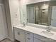 Bright bathroom featuring dual sinks, quartz countertops and large mirror at 148 Shepherds Landing Dr, Mooresville, NC 28115