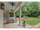 Inviting back porch with comfortable seating and a view of the landscaped backyard at 1579 Queens W Rd, Charlotte, NC 28207