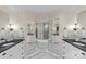 Elegant bathroom with dual sinks, marble countertops, mosaic floors, and a glass-enclosed shower at 1579 Queens W Rd, Charlotte, NC 28207