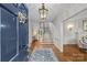 Inviting foyer with hardwood floors, staircase, chandelier, and bright, neutral decor at 1579 Queens W Rd, Charlotte, NC 28207