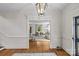 Foyer view into living room, showcasing hardwood floors, trim, and neutral colors at 1579 Queens W Rd, Charlotte, NC 28207