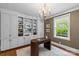 Bright home office with custom built-ins, neutral tones, and a modern chandelier at 1579 Queens W Rd, Charlotte, NC 28207
