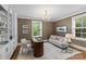 Comfortable home office with custom built-ins, neutral tones and bright, natural light at 1579 Queens W Rd, Charlotte, NC 28207