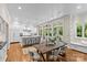 Open kitchen and dining area, perfect for entertaining, features an island, table, and large windows with back yard views at 1579 Queens W Rd, Charlotte, NC 28207