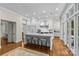 Elegant kitchen with large island, white cabinets and stainless steel appliances, perfect for cooking and entertaining at 1579 Queens W Rd, Charlotte, NC 28207